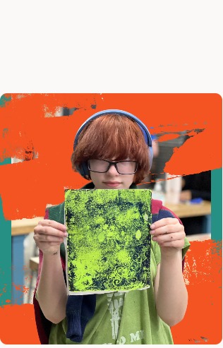 Student holding bright green artwork